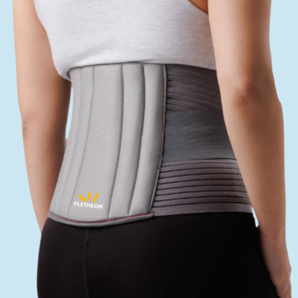 Woman wearing PLETHEON lumbar support belt providing lower back support and pain relief