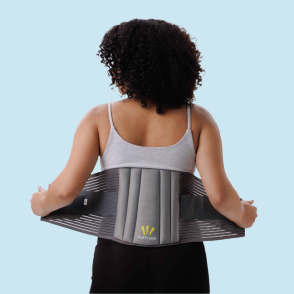 Woman wearing PLETHEON lumbar support belt providing lower back support and pain relief