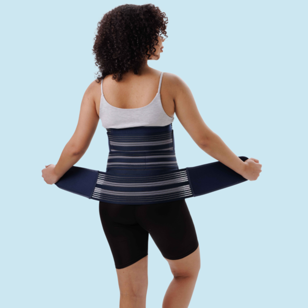 Woman wearing 3-in-1 postpartum abdominal belt for post pregnancy belly and waist support